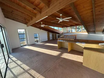 an empty room with a ceiling fan and wooden ceilings at Suite Dreams Gorgeous Garden Holiday Home in Panorama