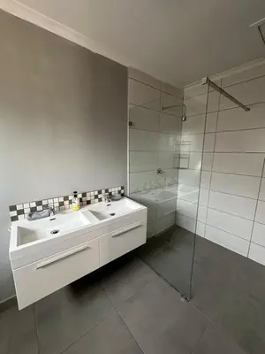 a white bathroom with a sink and a shower at Suite Dreams Garden Dream Cottage in Panorama