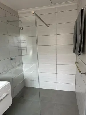 a shower with a glass door in a bathroom at Suite Dreams Garden Dream Cottage in Panorama