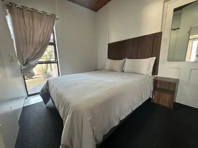 a bedroom with a large bed with a window at Suite Dreams Spacious Apartment in Panorama