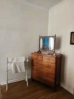 a mirror on top of a dresser in a room at Cosy en-suite room Stellenbosch in Stellenbosch