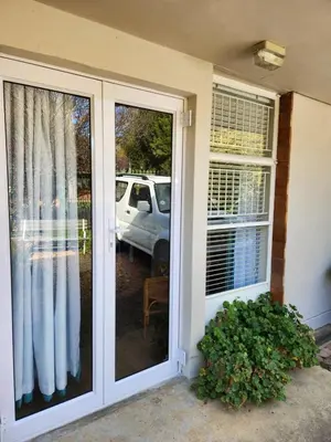 a sliding glass door of a house with a window at Cosy en-suite room Stellenbosch in Stellenbosch