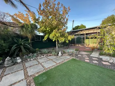a backyard with a garden with a lawn at Suite Dreams Adorable One Bedroom Apartment in Panorama