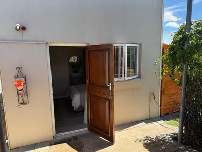 a door leading into a room with a bedroom at Courtyard Hideaway in Kenridge
