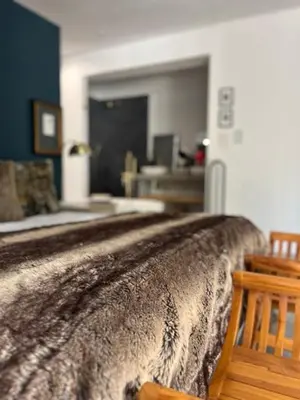 a bedroom with a bed with a blanket on it at Helder Haven Cottage in Somerset West