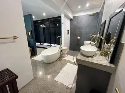 a bathroom with two sinks and a bath tub at Helder Haven Cottage in Somerset West