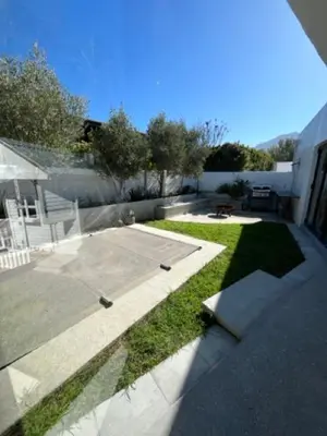 a view of a backyard with a basketball court at Helder Haven Cottage in Somerset West