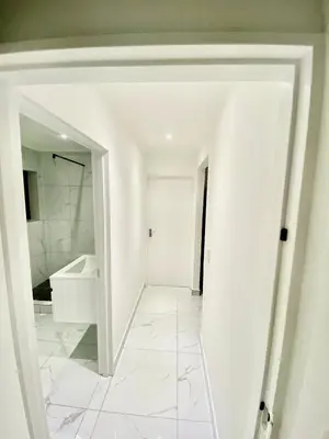 a white bathroom with a sink and a mirror at Chill & Cozy shared apartment with Michael in Cape Town