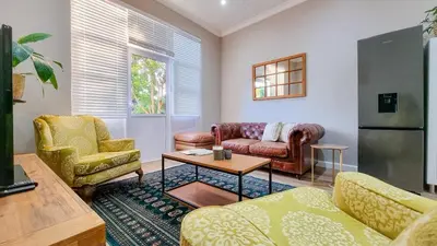 a living room with two couches and a table at La Vita e Bella in Wellington