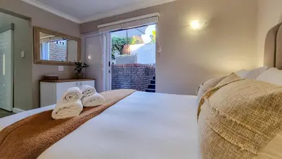 a bedroom with a bed with towels on it at La Vita e Bella in Wellington