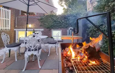 a patio with a fire grill and a table and chairs at La Vita e Bella in Wellington