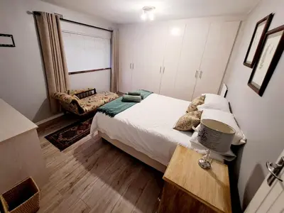 a small bedroom with a bed and a window at Mooiloop Self Catering in Bellville