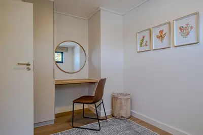 a hallway with a chair and a mirror at Whale Melody Love Hermanus in Hermanus