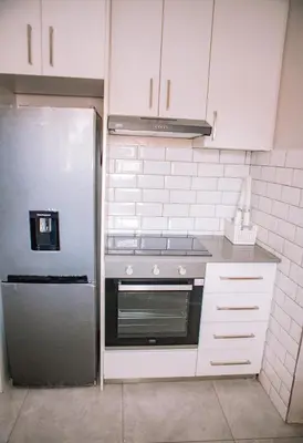 a kitchen with a stove and a refrigerator at 26 on Balfour Crescent in Silver Sands
