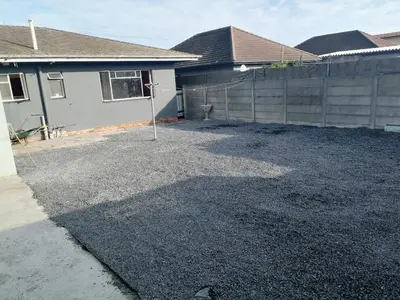 a yard in front of a house with a fence at 72 the trout lodge in Goodwood