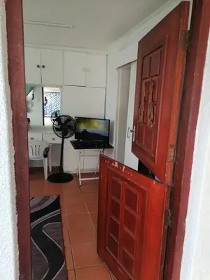 an open door to a living room with a television at 72 the trout H lodge in Goodwood