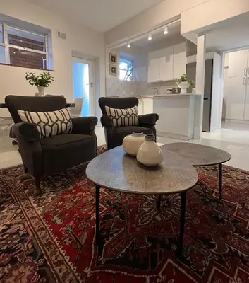a living room with two chairs and a table at Bosch & Bloom in Stellenbosch