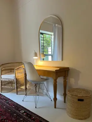 a desk with a mirror and a chair in a room at Bosch & Bloom in Stellenbosch