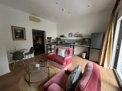 a living room with a couch and a table at Central Somerset Stay in Somerset West