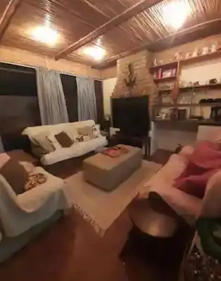 a living room with a couch and a table at Cosy Stay - Homestay with Linda & Garfield in Gordonʼs Bay