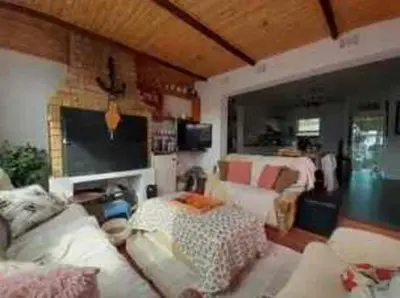 a living room with a couch and a table at Cosy Stay - Homestay with Linda & Garfield in Gordonʼs Bay
