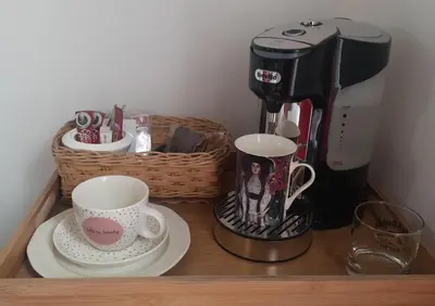 a coffee maker and two cups on a shelf at Cosy Stay - Homestay with Linda & Garfield in Gordonʼs Bay