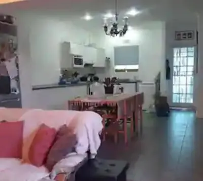 a living room with a couch and a table at Cosy Stay - Homestay with Linda & Garfield in Gordonʼs Bay