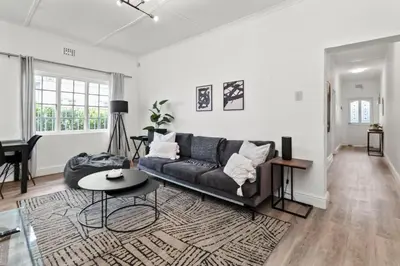 a living room with a couch and a table at Atticus Self Catering Accommodation in Cape Town