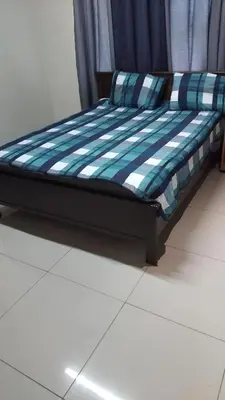 a bed sitting on a tiled floor in a room at Wilcuma Lodge in Plattekloof