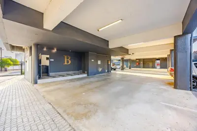 a empty parking lot in front of a building at Modern 2 bed, 2 bath, 14B- Blouberg in Bloubergstrand