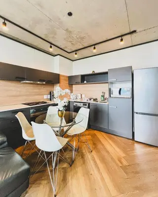 a kitchen and dining room with a table and chairs at Olive Apartment on Bridgewaters in Cape Town