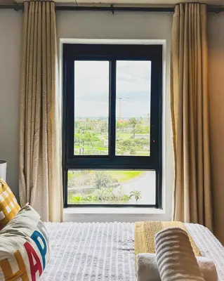 a bedroom with a large window and a bed at Olive Apartment on Bridgewaters in Cape Town