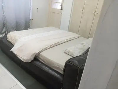 a bed with two pillows on top of it at Halibut Suite in Strand