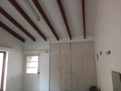a room with white walls and wooden ceiling at Halibut Suite in Strand
