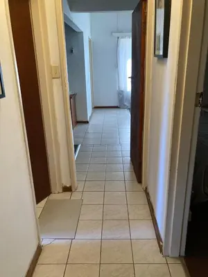 a hallway with a tiled floor in a house at Halibut Suite in Strand