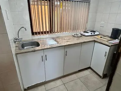 a kitchen with a sink and a counter top at M&D Guest House in Bellville