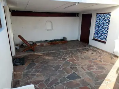 an empty room with a stone floor and a window at 72 Hamilton the trout lodge in Goodwood