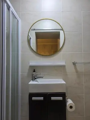 a bathroom with a sink and a mirror at Spring Tide Beach Flat Child Petfriendly Hot Tub in Bloubergstrand