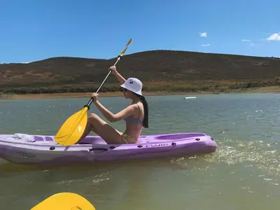 a woman in a purple kayak on the water at Vineyard House in Worcester