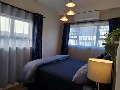 a bedroom with a bed and a window at Mukuru Okunene in Strand