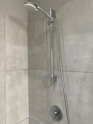 a shower with a shower head in a bathroom at The Madge Self Catering in Paarl