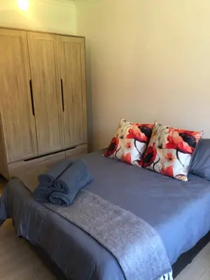 a bed with two pillows on it in a bedroom at River Front in Stellenbosch