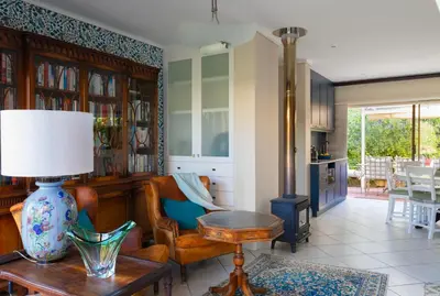 a living room with a vase on a table at Kaniek - Guest Suite in Somerset West
