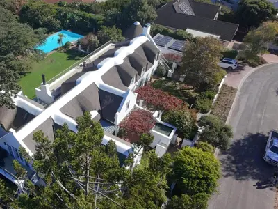 an overhead view of a large white house with a pool at The Bothey House in Somerset West