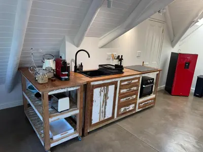 a kitchen with a counter and a red refrigerator at The Bothey House in Somerset West
