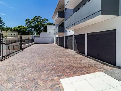 a brick driveway in front of a building at FamoHof Apartments in Stellenbosch