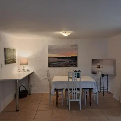 a dining room with a table and chairs at Vermont Garden Cottage in Hermanus