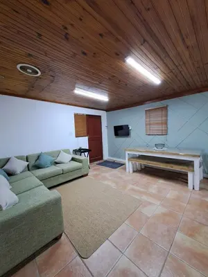 a living room with a couch and a table at Azzure Apartments 4 sleeper Crawford in Cape Town