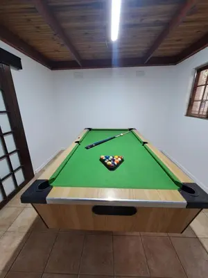 a pool table in a room with a sidx sidx sidx at Azzure Apartments 4 sleeper Crawford in Cape Town