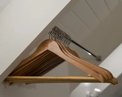 a shelf with two wooden utensils on it at Arch Window garden apartment in Stellenbosch